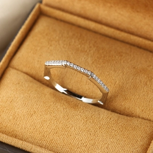 Minimalist silver geometric hexagonal ring with clear zircon stones on a velvet box