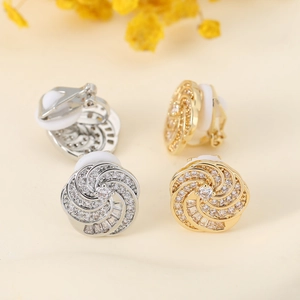 Detail view of rotating zircon ear clips in gold and silver finish with soft pads