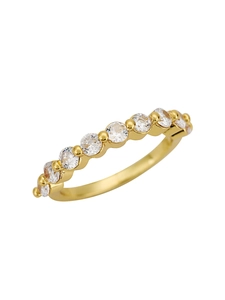 Macro shot of gold eternity ring with nine round-cut diamonds in shared prong setting