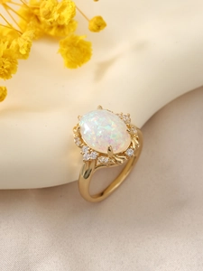Macro detail of golden opal ring featuring iridescent stone and sparkling crystal accents