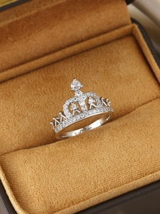 Macro shot of silver crown ring with cubic zirconia inlay in a brown velvet gift box