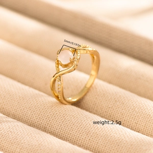 Elegant gold minimalist ring featuring a 5mm round pink moonstone and twisted band