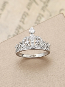 Detailed macro view of a vintage crown ring with polished silver finish and pavé zircons