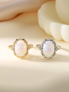 Detailed close-up of vintage opal rings with intricate hollow petal gold settings