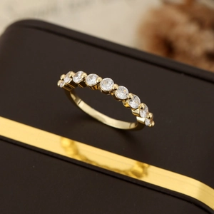 Elegant gold band ring with classic channel-set round sparkling cubic zirconia stones