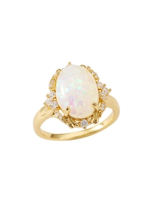 Macro detail of vintage gold opal ring with sparkling rainbow colors and halo stones