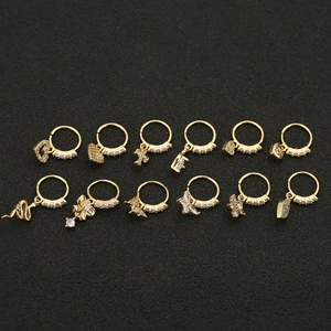 Close-up of a 12-piece golden hoop earring set with diverse zircon pendants on black display