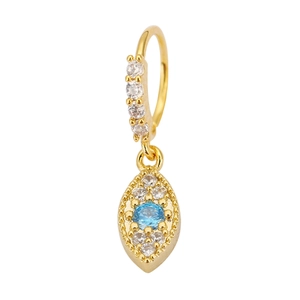 Macro shot of gold-plated huggie earring with blue marquise zircon pendant and crystals