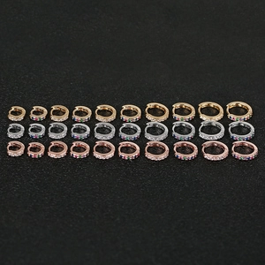 Macro detail of huggie earrings in three metal colors with micro-pave zirconia settings