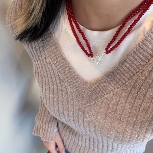 Detail of double-layer red agate beaded necklace with silver metal OT toggle clasp