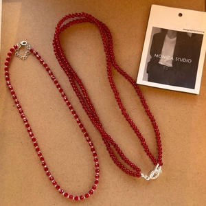 Detailed macro view of red agate beaded necklace set with elegant silver metal clasps