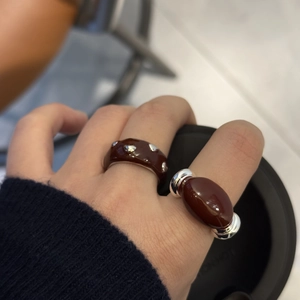 Fashionable set of two deep brown enamel rings with silver accents for a modern look