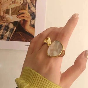 Gold-plated titanium steel ring with large white shell inlay in a geometric design