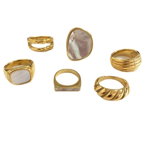 Set of six gold titanium steel rings with shell inlays and twisted geometric designs