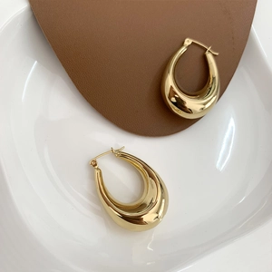 Minimalist gold titanium steel oval hoop earrings with a high polished mirror finish