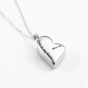 Macro detail of heart urn necklace with Forever In My Heart and MOM engraving