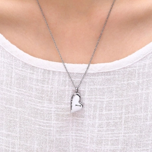 Close-up of Mom heart urn pendant necklace engraved with Forever in My Heart on model