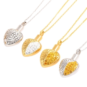 Four heart-shaped perfume lanyards in gold and silver with rhinestones on white backdrop