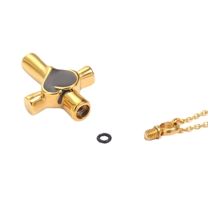 Golden stainless steel cross urn necklace with black heart and screw seal lid details