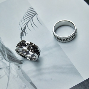 Men's titanium steel spinner chain rings in silver and black colors for a punk style