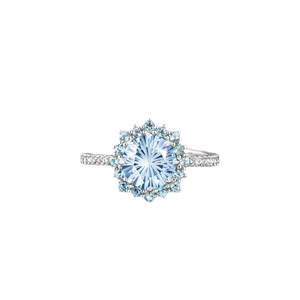 Light blue cluster ring with round crystal and silver pavé accents on white background