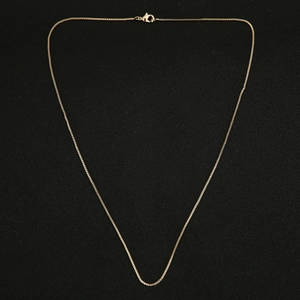 Close-up of polished golden box chain necklace with a secure lobster clasp closure