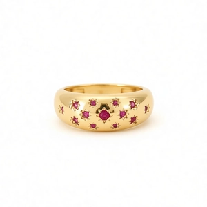 Polished gold dome ring for women with red rubies set in engraved star patterns