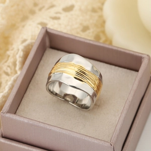 Two-tone wide wave ring with silver metal and gold brushed finish in a jewelry box