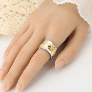 Wide two-tone wave ring with gold wire texture shown on model hand