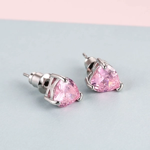 Detail of pink triangle gemstone earrings with silver K-shaped claw setting and studs