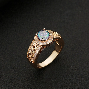 Macro shot of colorful iridescent gemstone ring with sparkling pavé diamonds and filigree band