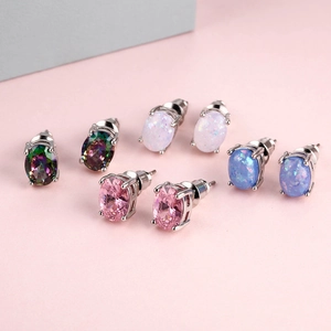 Set of four minimalist oval opal stud earrings in silver prong settings with multiple colors