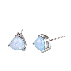 Minimalist heart-shaped blue opal stud earrings with silver metal base on white background