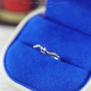 Elegant leaf-shaped wave ring with double circular crystals in a blue jewelry box