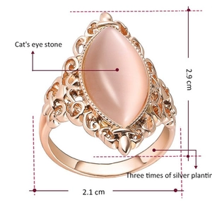 Detail view of pink cat's eye stone ring with silver plating and dimensions info