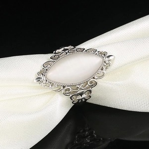 Macro shot of vintage silver ring featuring a large white marquise-cut cat eye gemstone