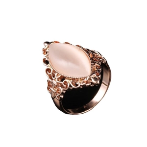 Vintage rose gold filigree ring with a large marquise cut pink opal cat eye stone