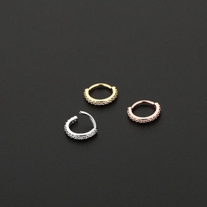 Three hinged cartilage earrings in gold, silver, and rose gold with pavé zirconia
