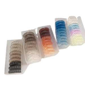 5 packs of colorful spiral telephone cord hair ties in transparent storage boxes