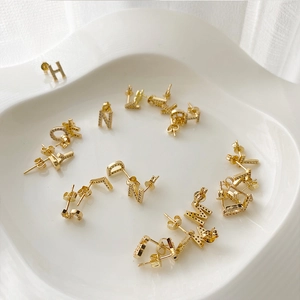 Elegant 925 silver needle gold earrings with micro-inlaid zircon letters on ceramic plate