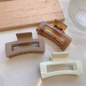 Three-piece large rectangular hair claws in matte pink, amber brown, and cream white