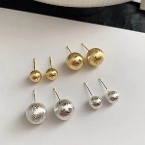 Set of four pairs of brushed gold and silver spherical stud earrings in two sizes