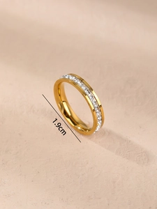 Detailed view of gold plated ring with square cut zircons and 1.9cm inner diameter size