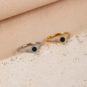 Macro shot of minimalist titanium steel rings with roman numerals and crystals in gold and silver