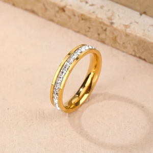 Minimalist gold eternity band featuring white square-cut zircon channel setting on stone