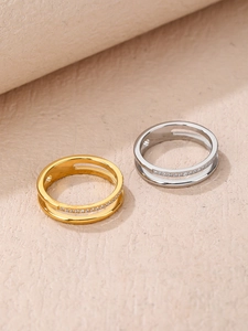 Detail of double-layer hollow rings in gold and silver with micro-pave crystals