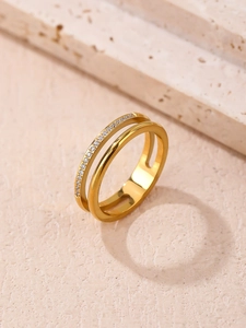 Detail of gold double-layer titanium ring featuring micro-pave zirconia insets