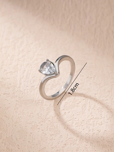 Detailed view of curved ring with pear-shaped zircon and 1.8cm diameter measurement