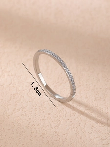 Macro shot of a slim titanium steel ring with pavé crystals showing the 1.8cm inner diameter