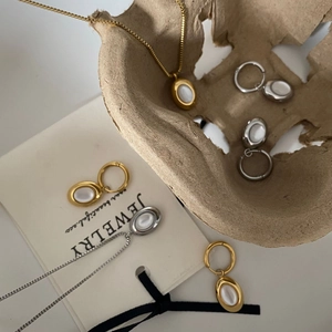 Detailed set of 18K gold plated oval white shell necklaces and matching hoop earrings